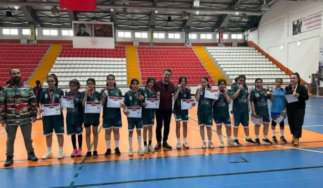 Kars Ziya Gökalp Ortaokulu Kız Futsal Takımı Bölge Şampiyonası'nda kupa kaldırıyor.